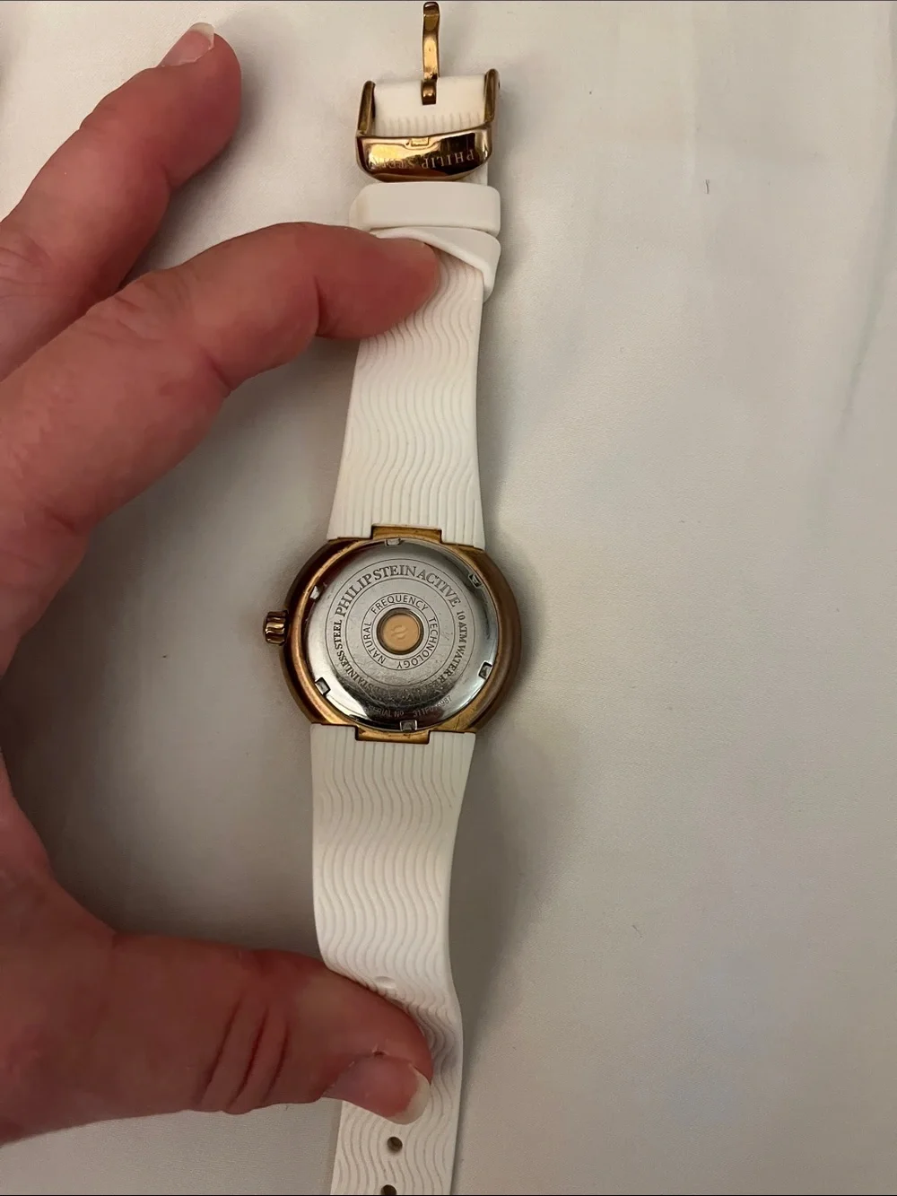PHILIP STEIN gold bezel watch with white rubber strap (needs new battery)
